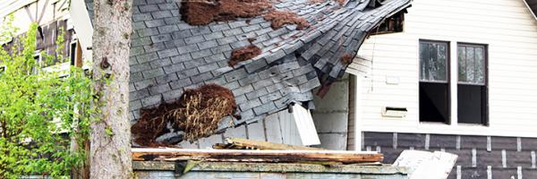 The roof of a home falling into disrepair